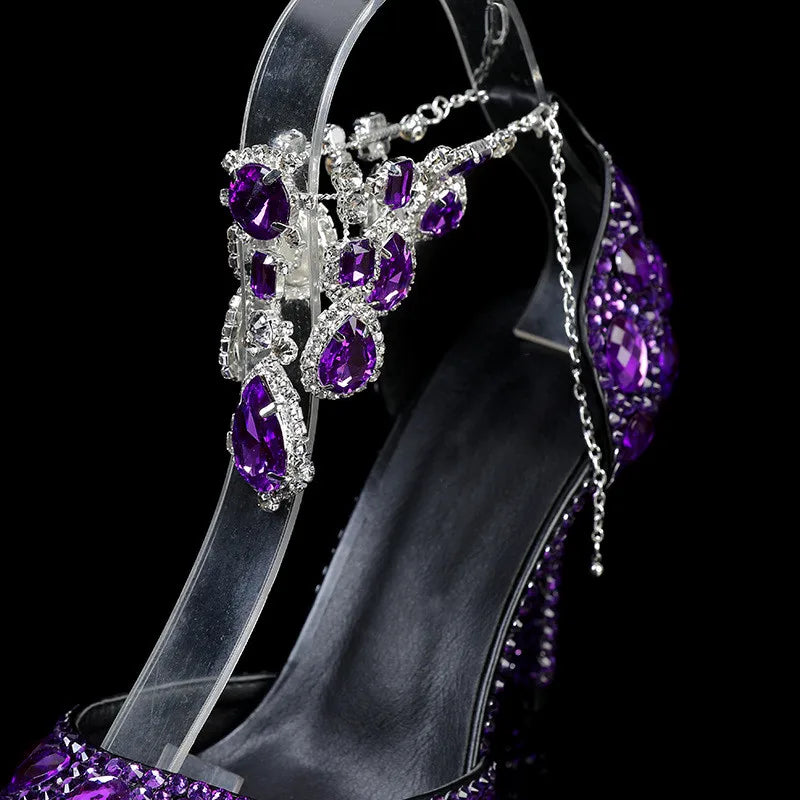 Jeweled high-heeled shoe with purple and clear stones on a black background