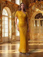 A woman in a gold dress standing in an opulent room with gold decor.