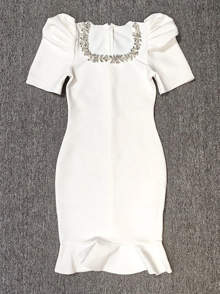 White dress with embellishments on a gray background