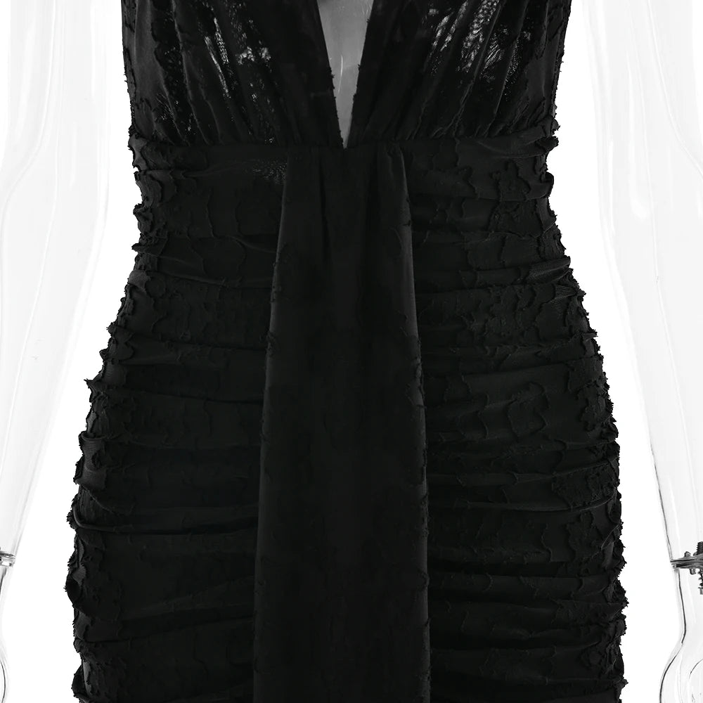 Black dress with ruffled details on a white background