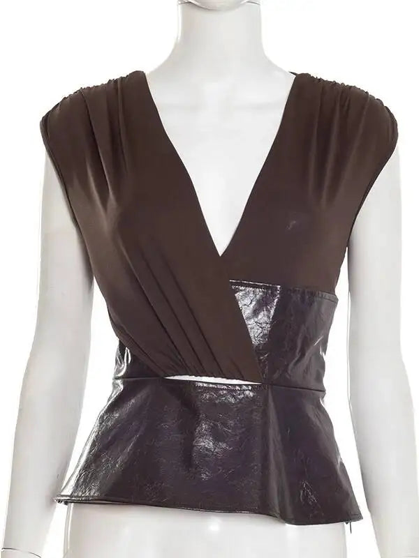Brown peplum top on a mannequin against a white background