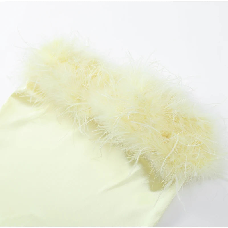 Light yellow feathered fabric on a white background