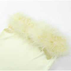 Light yellow feathered fabric on a white background