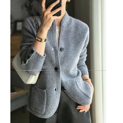 A woman wearing a luxurious Dark Grey  100% cashmere cardigan, showcasing its elegant drape and warmth. Golden Atelier 2