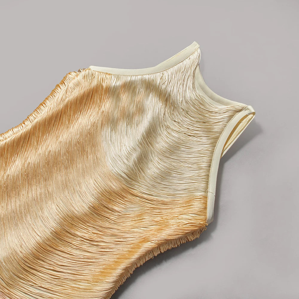 Close-up of a beige sleeveless top with ruffled details on a gray background