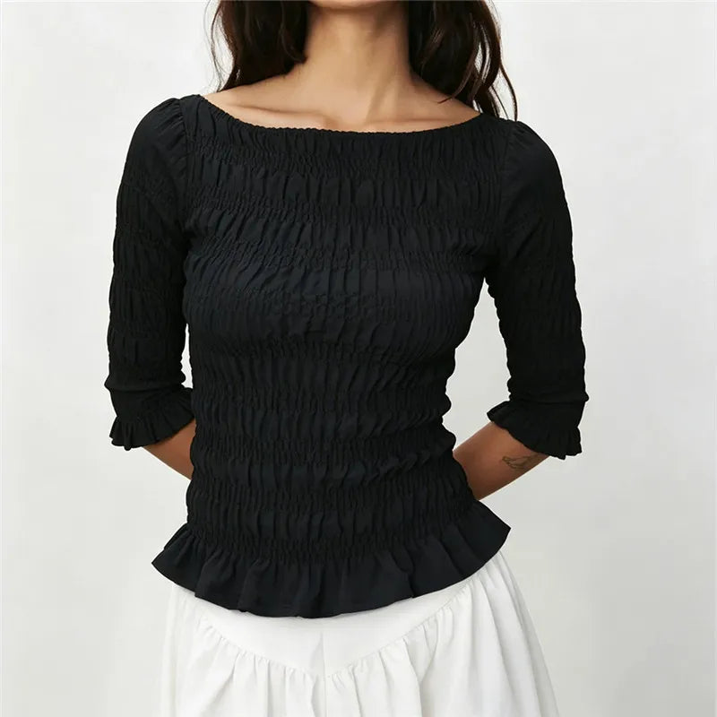Smocked 3/4 sleeve peplum top in black.