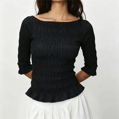 Smocked 3/4 sleeve peplum top in black.