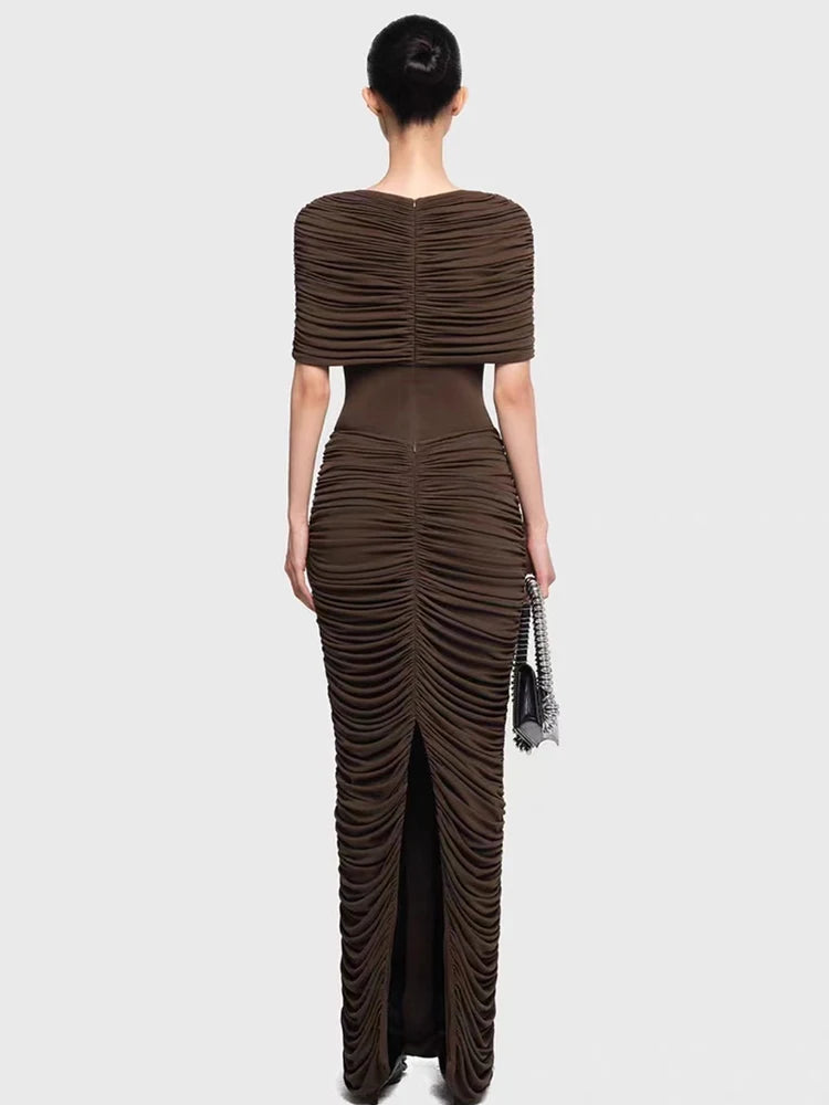 Woman wearing a brown ruched evening gown on a white background