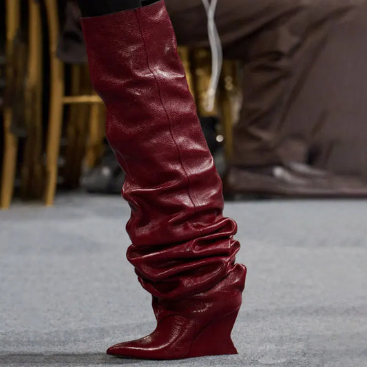 Red pleated wedge heel boot on foot