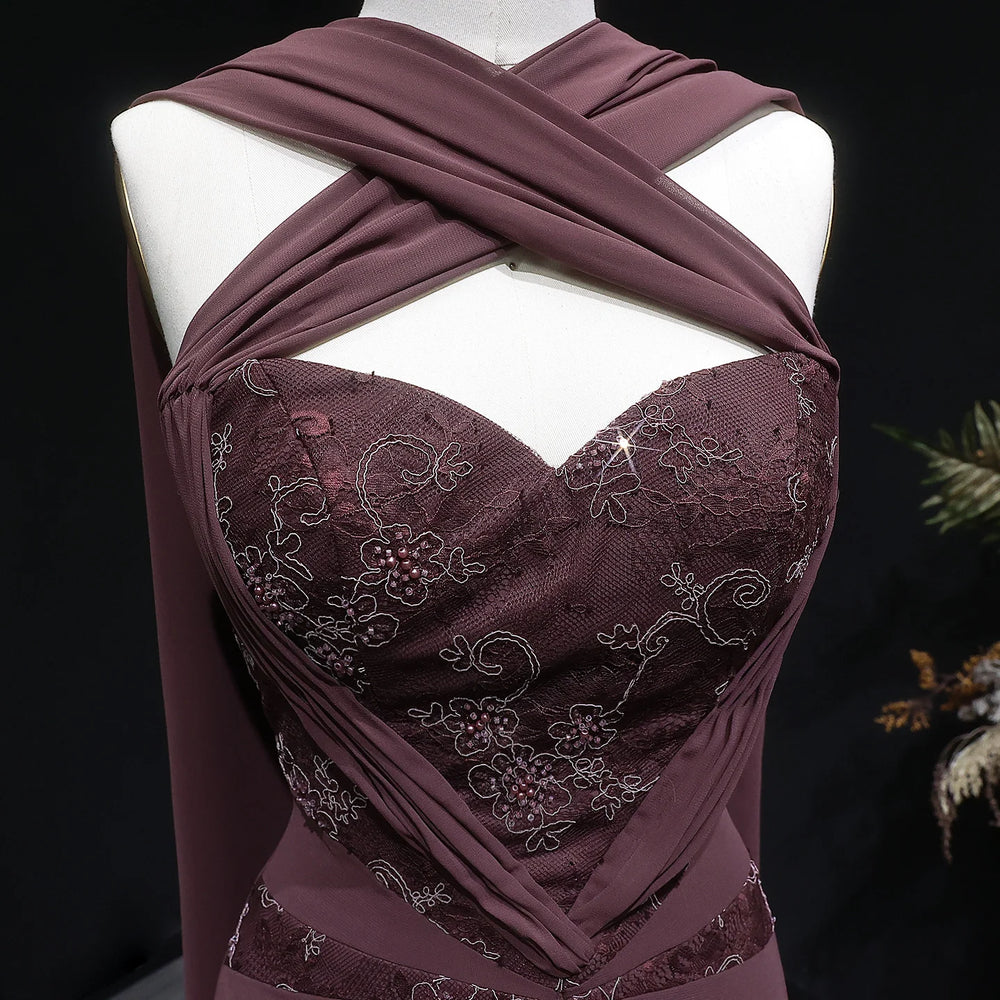 Detail of the intricate embroidery on the bodice of a halter neck chiffon evening dress.