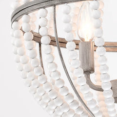 Close-up of a wooden bead pendant light, showcasing the natural texture and warm glow of the LED bulb. B