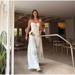 Floral print corset top and wide leg pants set on a model walking through a doorway.