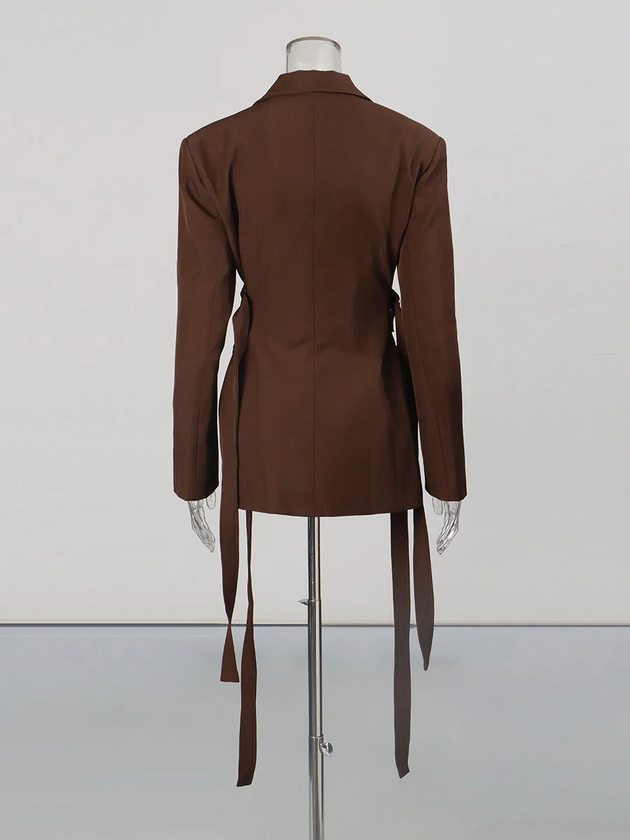 Brown dress on a mannequin against a white background