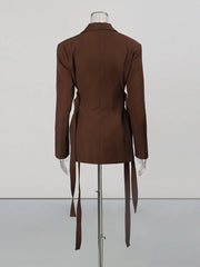 Brown dress on a mannequin against a white background