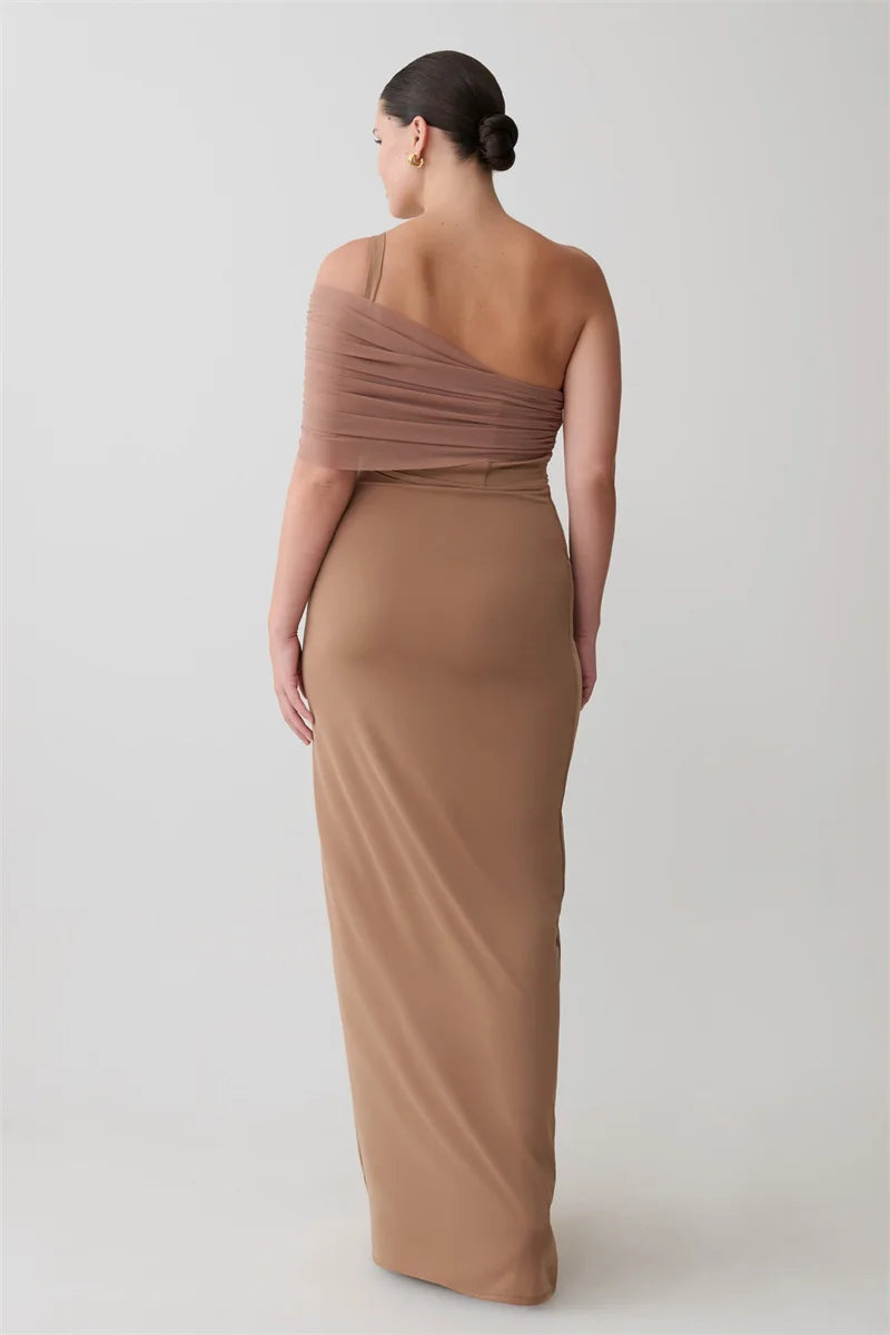 Woman wearing a brown one-shoulder dress on a white background