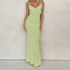 Woman wearing a green dress against a plain background