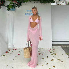 Model standing with a woven basket wearing a ribbed knit long sleeve cover-up and bikini bathing suit set.