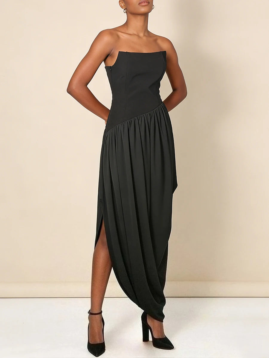Black strapless dress worn by a model against a beige background
