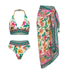 Flat lay of a floral print halter bikini top and wrap skirt.