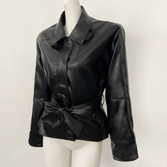 Black faux leather jacket with belt detail on a mannequin