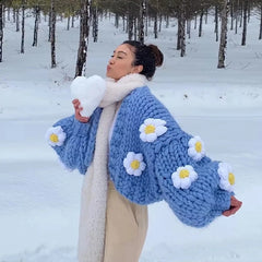 A woman wearing a cozy handmade flower cardigan with an open stitch design and puff sleeves.  Golden Atelier 6