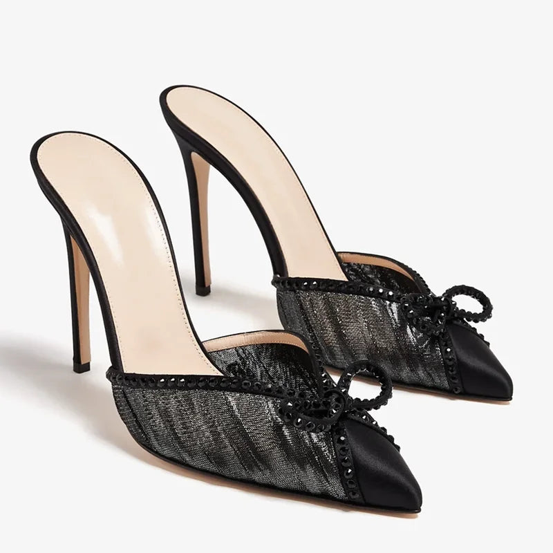 Black mesh stiletto pumps with embellished trim and a bow
