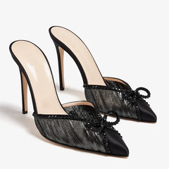 Black mesh stiletto pumps with embellished trim and a bow
