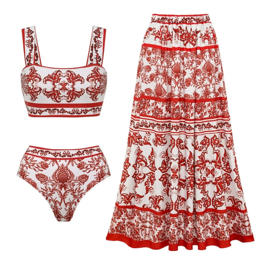 Flat lay of a red and white printed bikini set with a tiered maxi skirt.