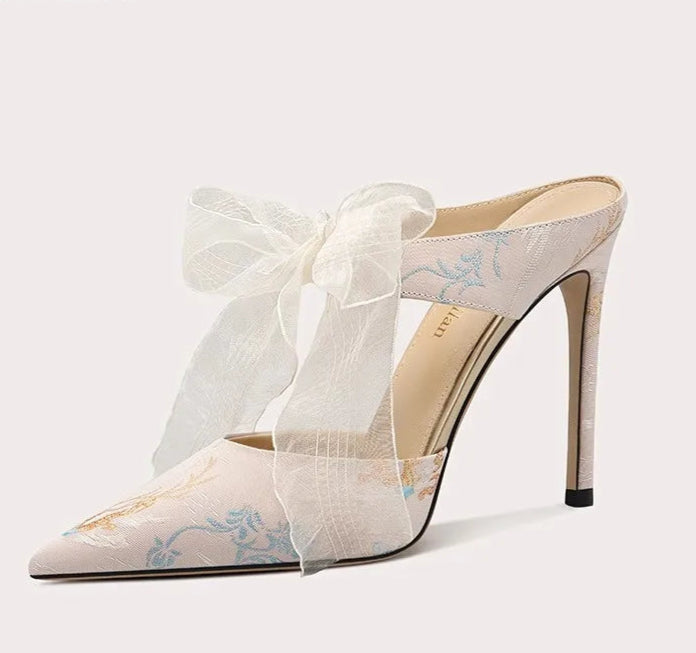 High-heeled shoe with a bow on a white background