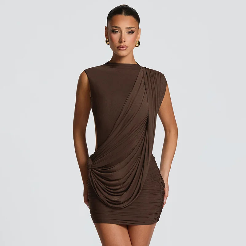 Woman wearing a brown draped dress on a light gray background