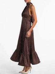 Woman wearing a brown polka dot dress on a white background