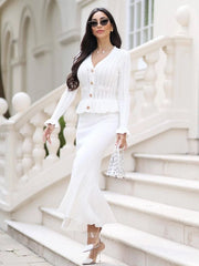 Woman in a white outfit standing on a staircase