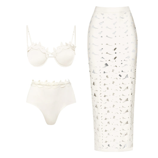 White bikini top and high-waisted briefs with floral-like embellishments and a matching white cutout midi skirt.