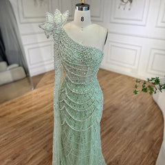   Mannequin  displaying the sage green mermaid evening gown, showcasing its flattering silhouette and flowing train. Golden Atelier 4