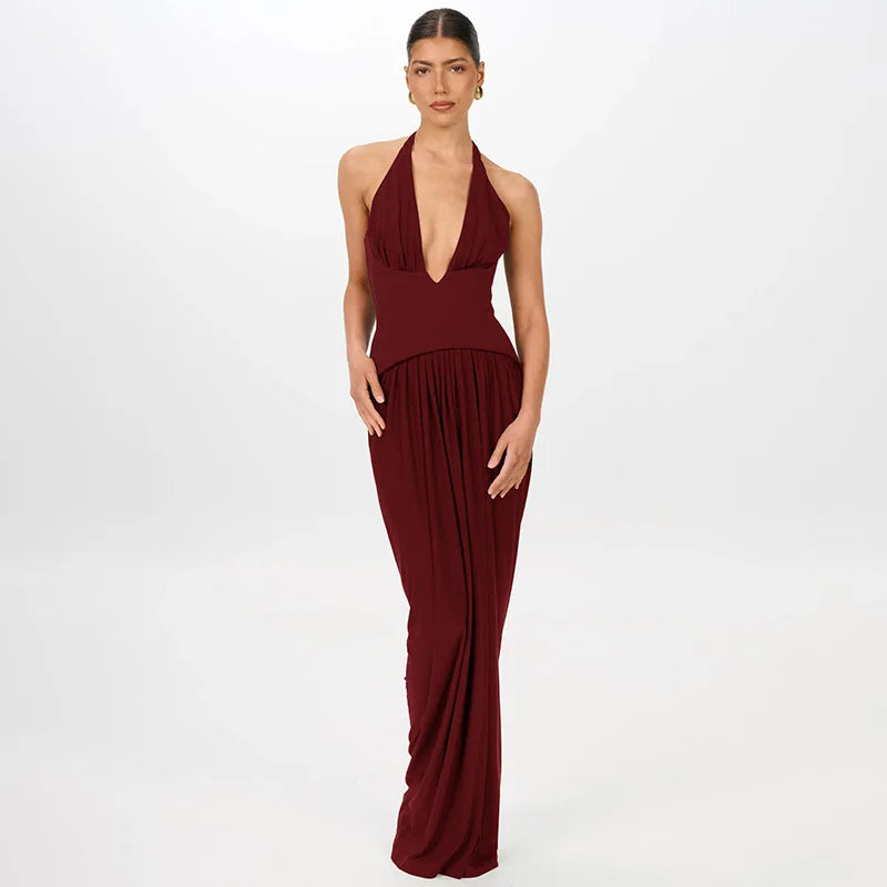 Woman wearing a burgundy halter neck gown on a white background