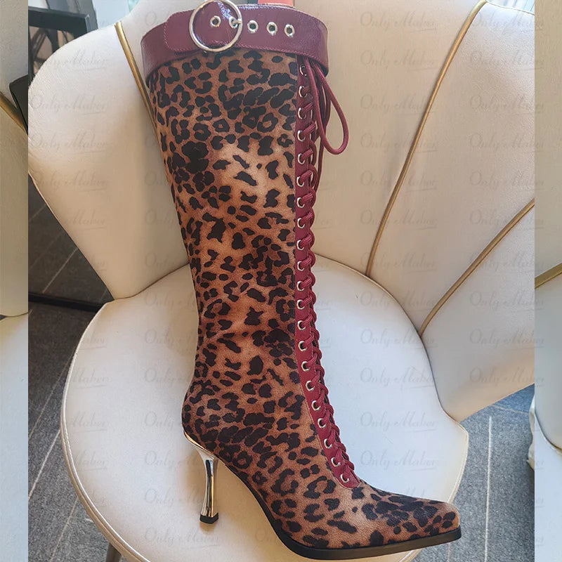Close-up of a leopard print lace-up knee high boot with red accents