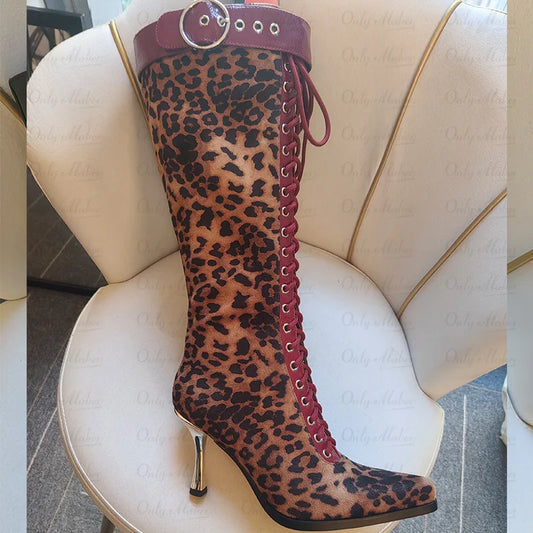Close-up of a leopard print lace-up knee high boot with red accents