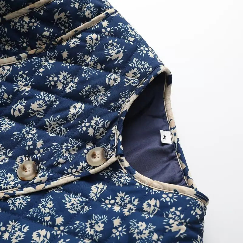 Detail of floral quilted collarless jacket neckline and buttons