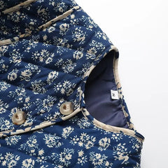 Detail of floral quilted collarless jacket neckline and buttons