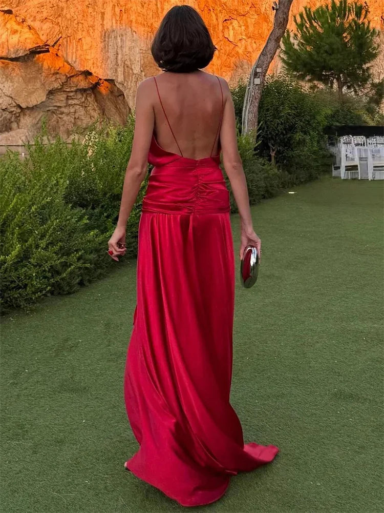 Model wearing red satin V-neck spaghetti strap maxi dress outdoors