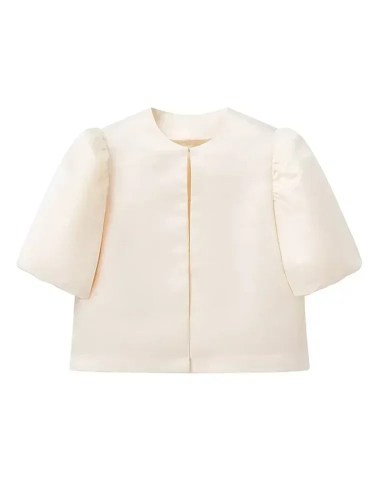 Cream-colored short top on a white background