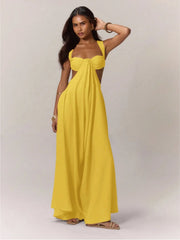 A woman wearing a yellow strapless jumpsuit against a plain background