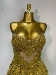 Close-up of gold sequined strapless mini dress bodice