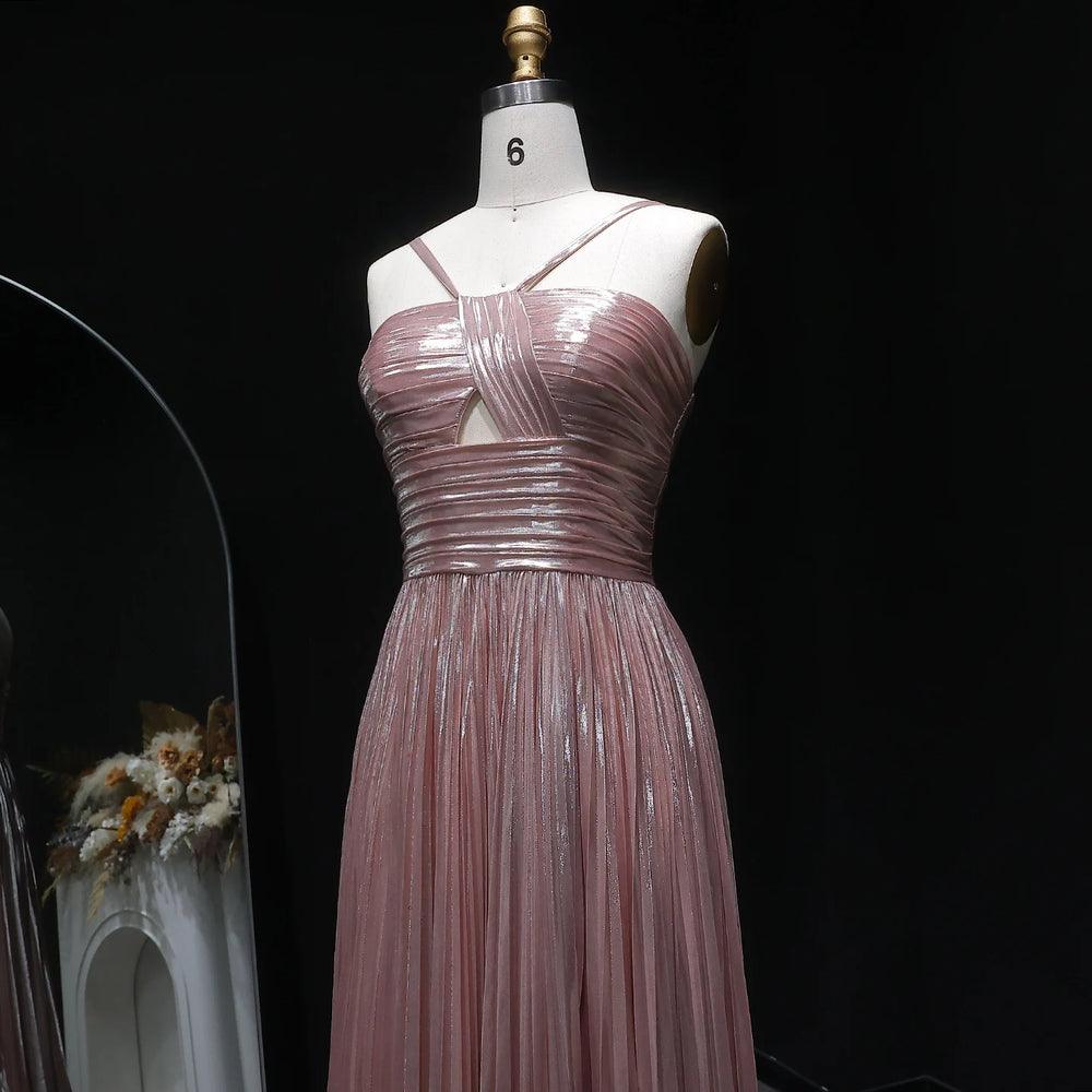 Pink evening gown on a mannequin against a black background