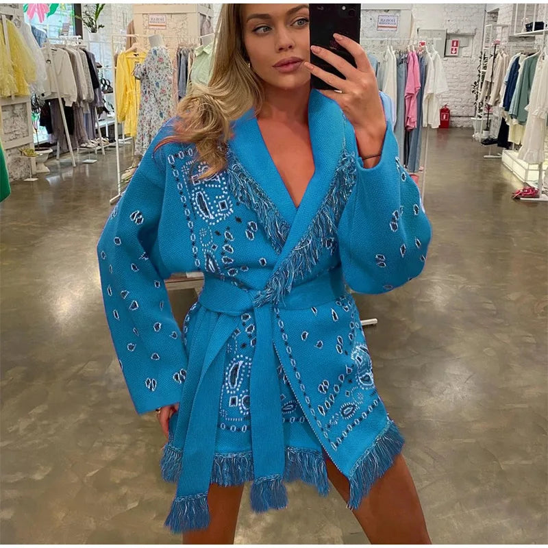 Woman wearing a blue embroidered robe in a clothing store.