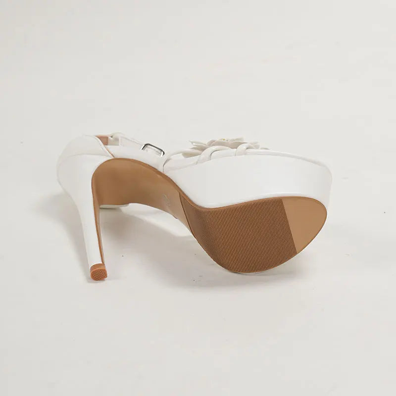 White high-heeled shoe with brown sole 