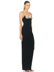 A model wearing a stunning black diamond spaghetti strap maxi dress with a backless design.