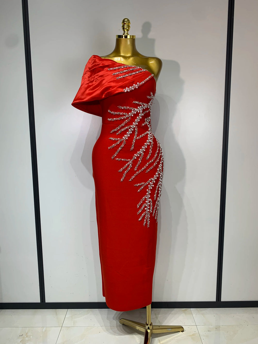 Red one shoulder dress with draped neckline detail
