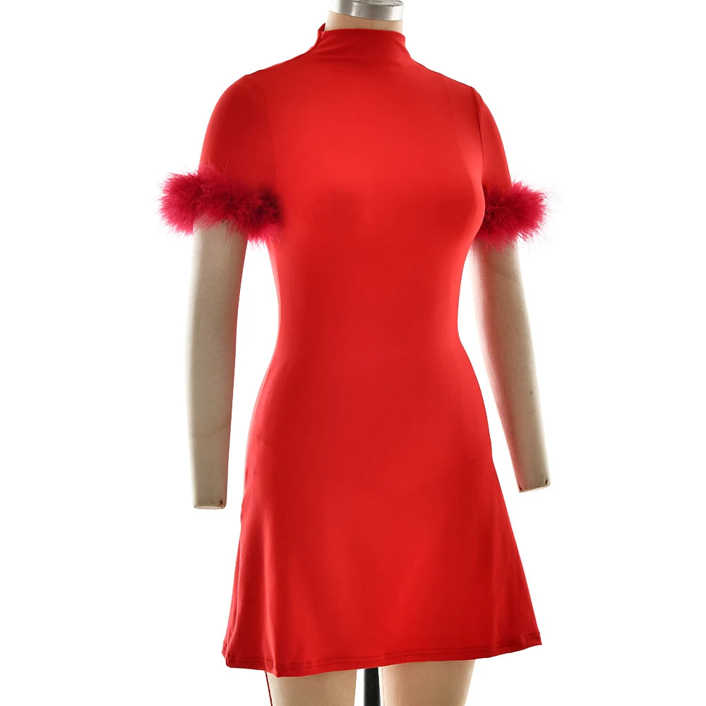 Red dress with feathered sleeves on a mannequin against a white background