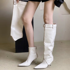 Women’s patent leather knee-high boots with pointed toe and buckle.